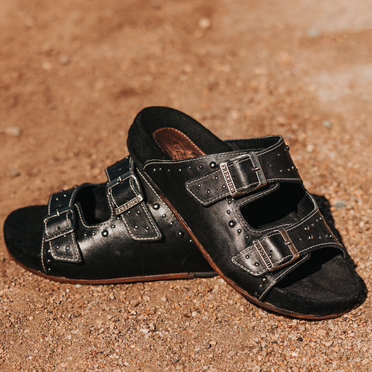 FREEBIRD women's Asher black sandal with adjustable belt buckles, a suede footbed and silver embellishments