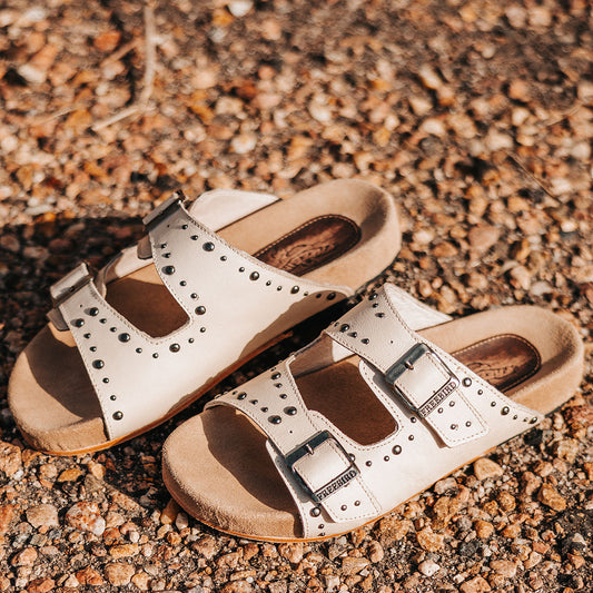 FREEBIRD women's Asher bone sandal with adjustable belt buckles, a suede footbed and silver embellishments