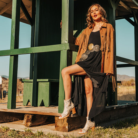 FREEBIRD women's Bela beige leather sandal with laser cut leather, braided accents and a working brass zip closure lifestyle image