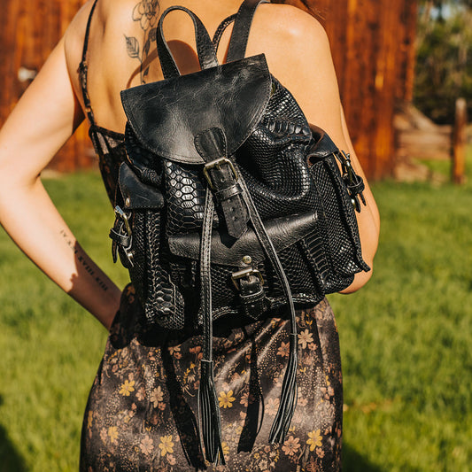 FREEBIRD Brett black snake embossed leather backpack with working exterior pockets and drawstring closure