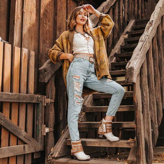 FREEBIRD women's Caspian ice multi leather bootie with back tie lacing, round toe construction and adjustable shaft belts lifestyle image