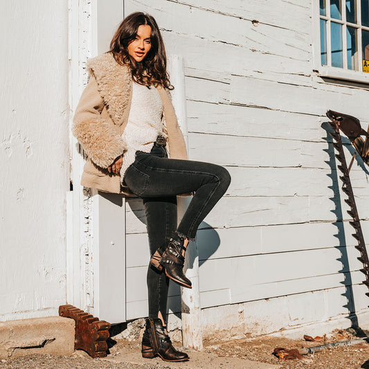 FREEBIRD women's Crue black distressed leather cutout ankle bootie with silver hardware straps and back lacing detail lifestyle image