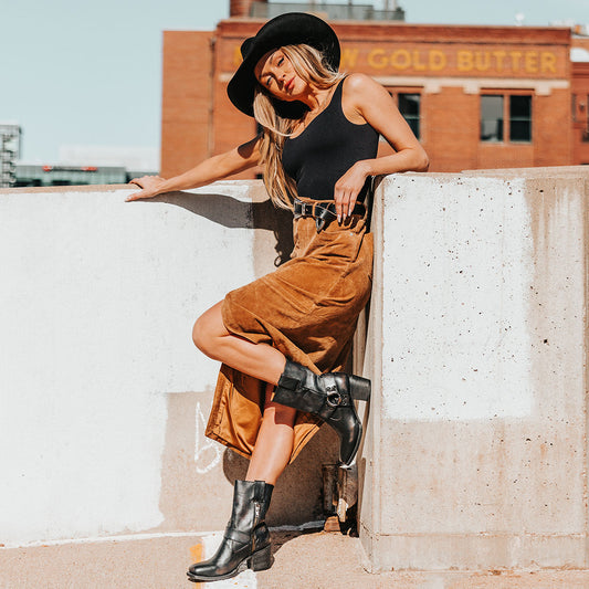FREEBIRD women's Darcy black leather boot with a studded ankle harness, leather pull straps, an inside zip closure and a square toe lifestyle image