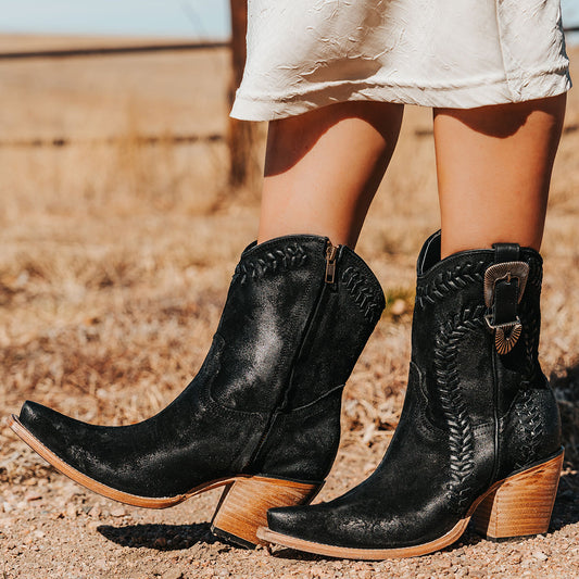 FREEBIRD women's Freya black suede bootie with whip stitch detailing, a snip toe silhouette and decorative vintage buckle. Finished with an inside working zipper.