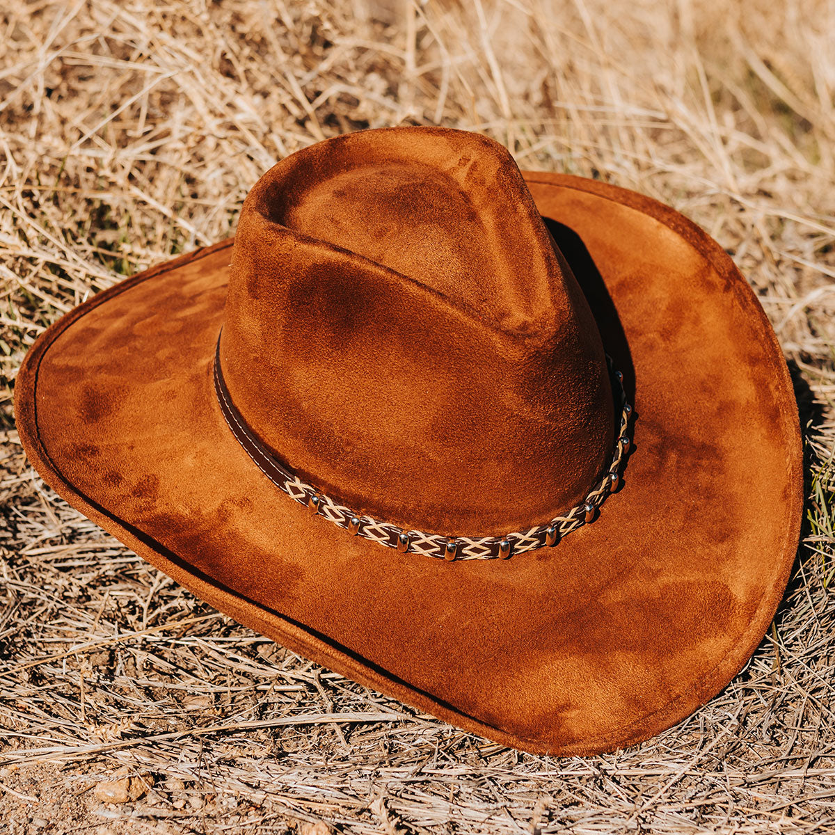 FREEBIRD Jones rust western cowboy hat featuring teardrop crown, upturned-brim, and braided leather band detailed view