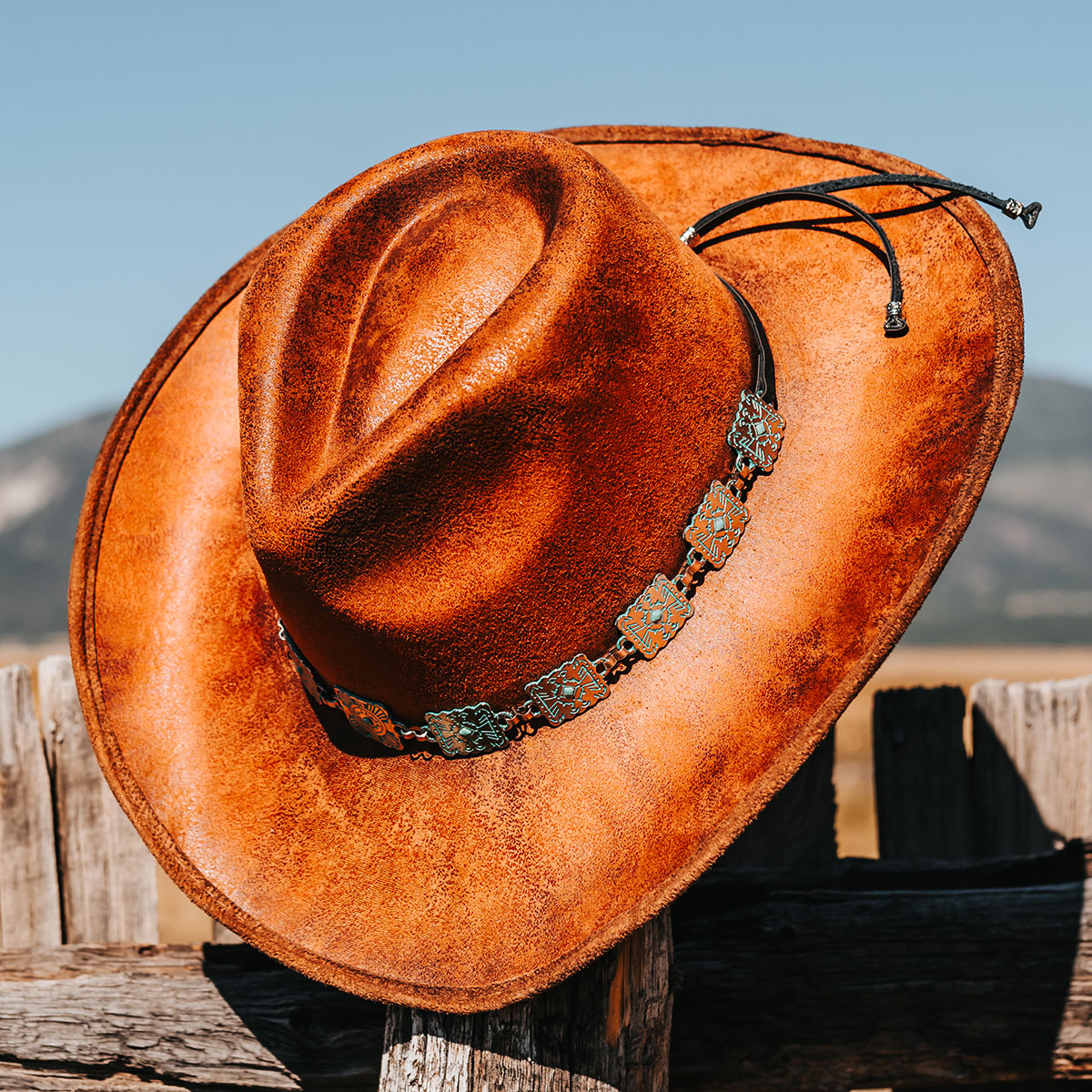 FREEBIRD Lasso rust distressed western hat featuring teardrop crown, upturned-brim, and turquoise metal band