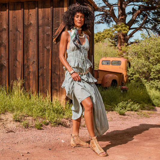 FREEBIRD women's Luna beige leather sandal with a gladiator silhouette, adjustable brass buckle and subtle stud embellishments on a low heel lifestyle