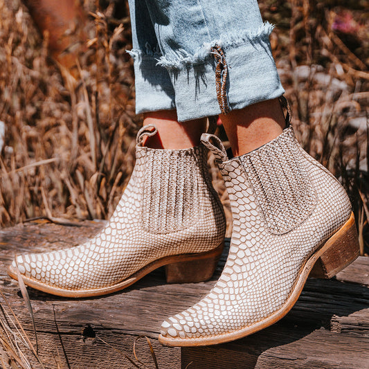 FREEBIRD women's Maeve embossed white snake leather bootie with pull tabs, gore detailing and a block heel