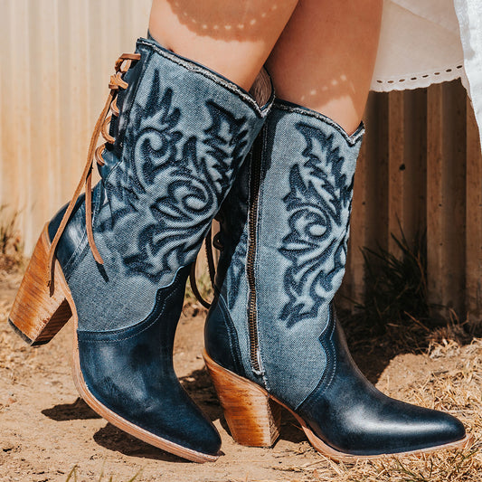 FREEBIRD women's Magnolia blue denim and leather boot with mono shaft stitching, back panel lacing and a curved pointed toe silhouette
