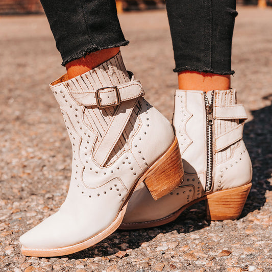 FREEBIRD women's Morgan beige leather ankle bootie with silver stud embellishments, gore detailing, and buckle straps