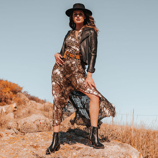 FREEBIRD women's Morgan black leather ankle bootie with silver stud embellishments, gore detailing, and buckle straps lifestyle image