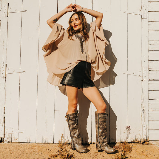 FREEBIRD women's Nighthawk stone tall boot with braided inlay detailing, brass zip closure, and round toe lifestyle image