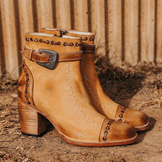 FREEBIRD women's Poppy Tan suede bootie with high heel, inside zip closure, decorative belt, and floral detailing