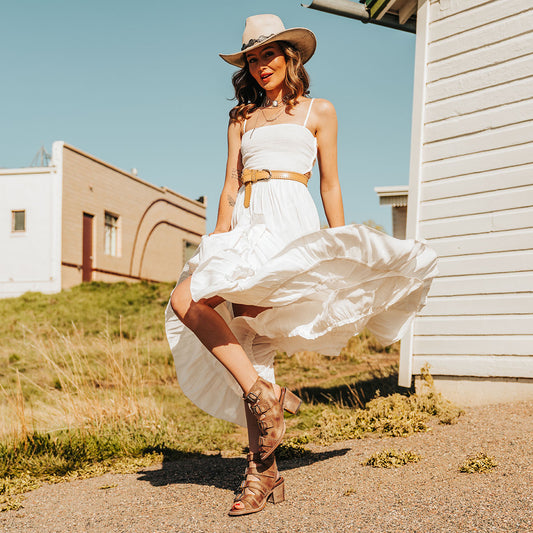 FREEBIRD women's Quail honey sandal with leather straps and working brass buckles lifestyle image