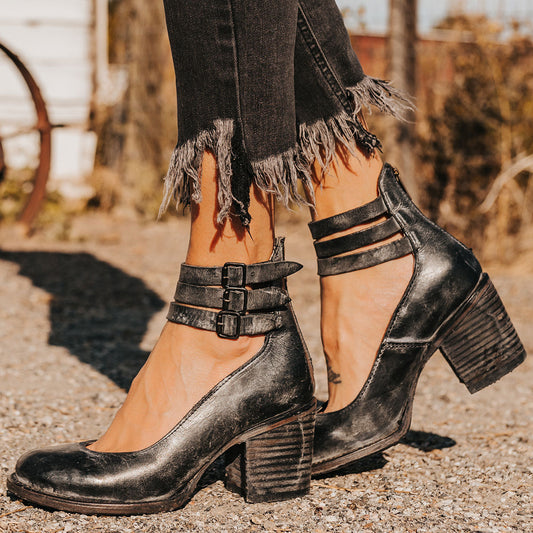 Black RANDI leather mid-heel shoes with triple buckle ankle straps, round toe, and a back zipper closure.