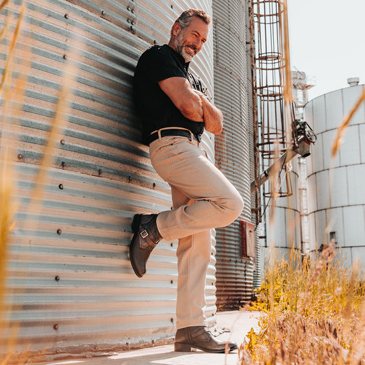 FREEBIRD men's Rumble black distressed leather boot with adjustable leather straps, a working brass zipper and stacked heel lifestyle image