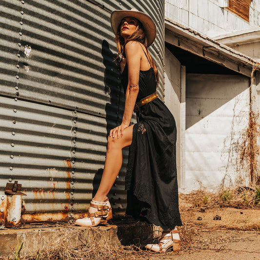 FREEBIRD women's Samantha beige bootie with stud detailing, contrasting straps with gold hardware, and inside zip closure lifestyle image