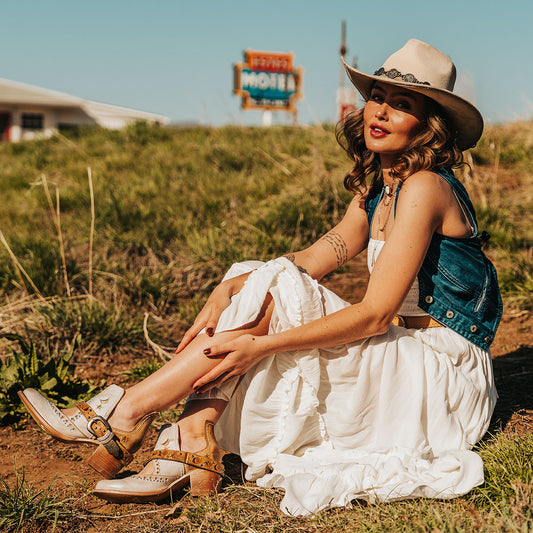 FREEBIRD women's Stardom beige bootie with silver stud detailing, laser cut leather, open ankles, and a decorative ankle strap lifestyle image