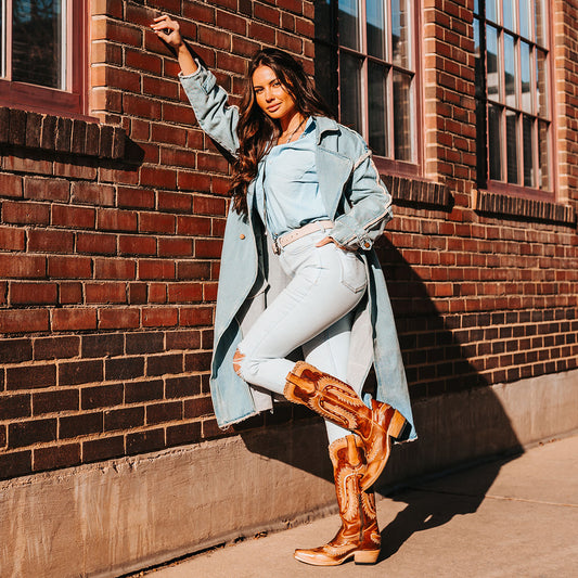 FREEBIRD women's Wayne cognac multi leather western mid-calf boot with whip-stitch and laser cut detailing, a snip toe and inside working brass zipper lifestyle image