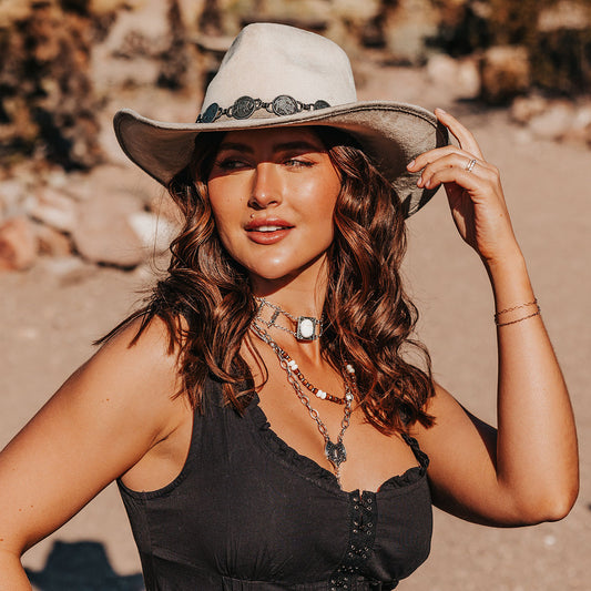 FREEBIRD Wyatt beige distressed faux suede hat with a pinched crown, curved brim and engraved coin belt lifestyle