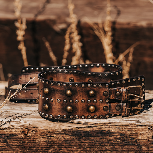 Black ALINE BELT wide leather waist-cincher with double gold-tone buckles and rustic metal stud embellishments.