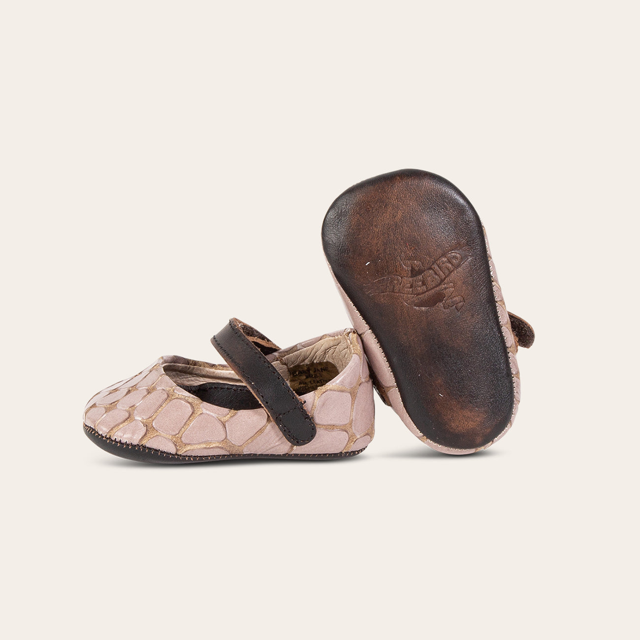 Side view showing leather strap detailing and soft leather imprinted sole on FREEBIRD infant baby Jane stone croco leather shoe