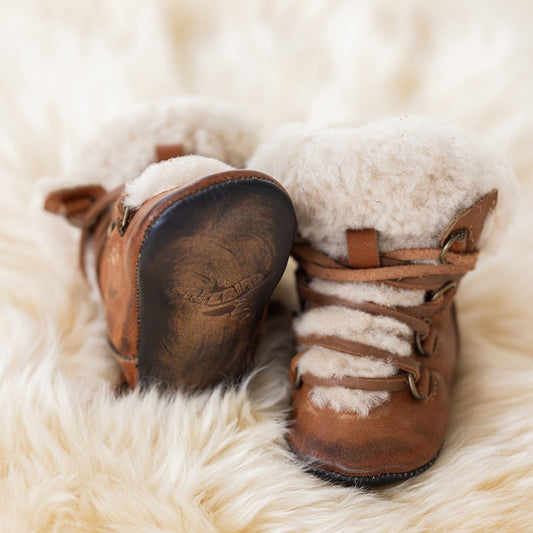 FREEBIRD infant baby Norway cognac shearling lined leather bootie with front lacing lifestyle image