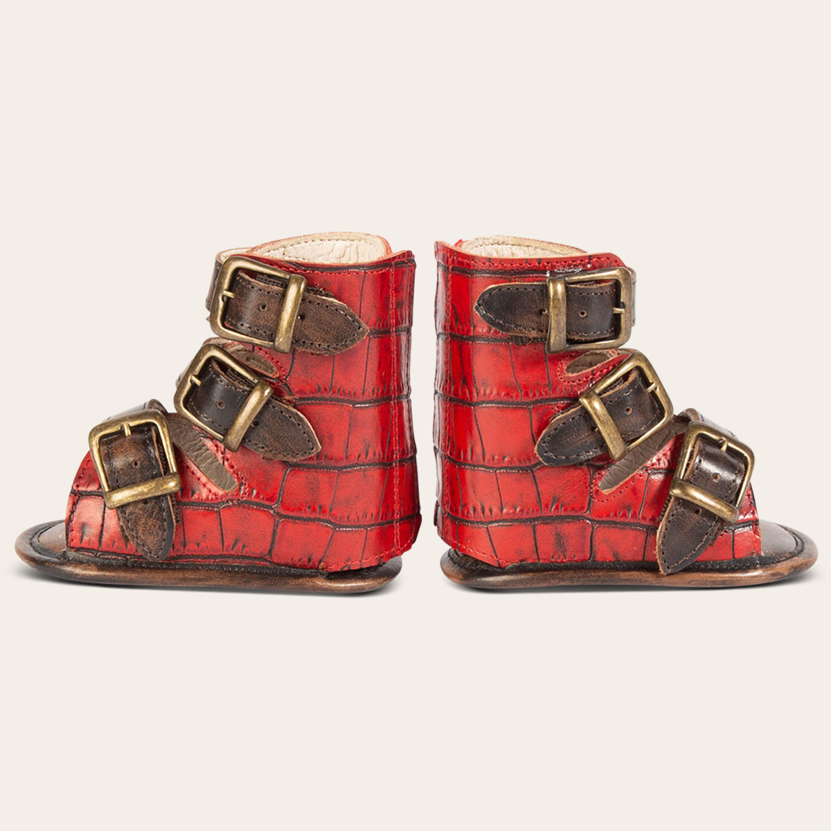 side view showing buckle fashion straps on FREEBIRD infant baby bond red croco sandal