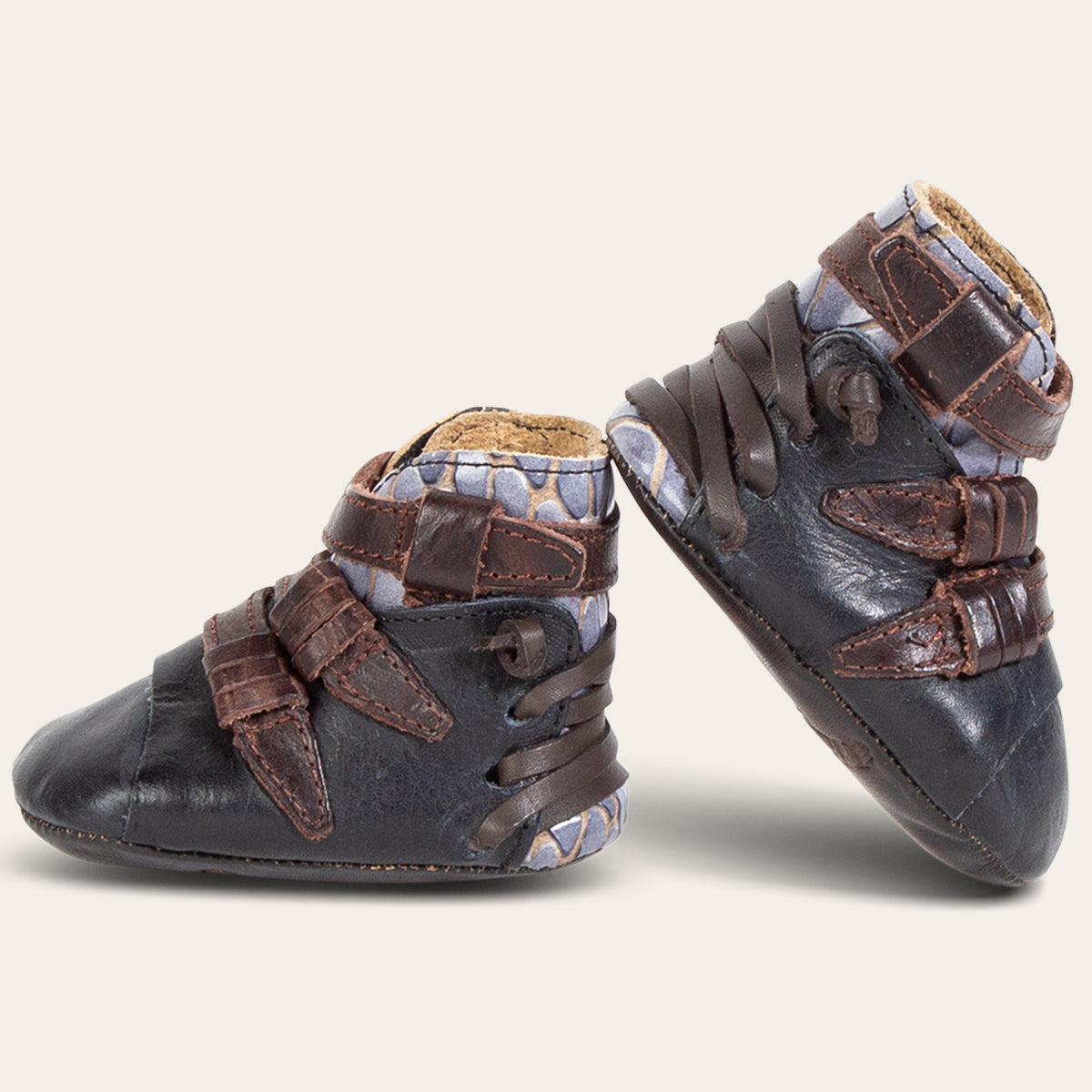 side view showing contrasting back lace and side strap detailing on FREEBIRD infant baby crue navy multi leather bootie