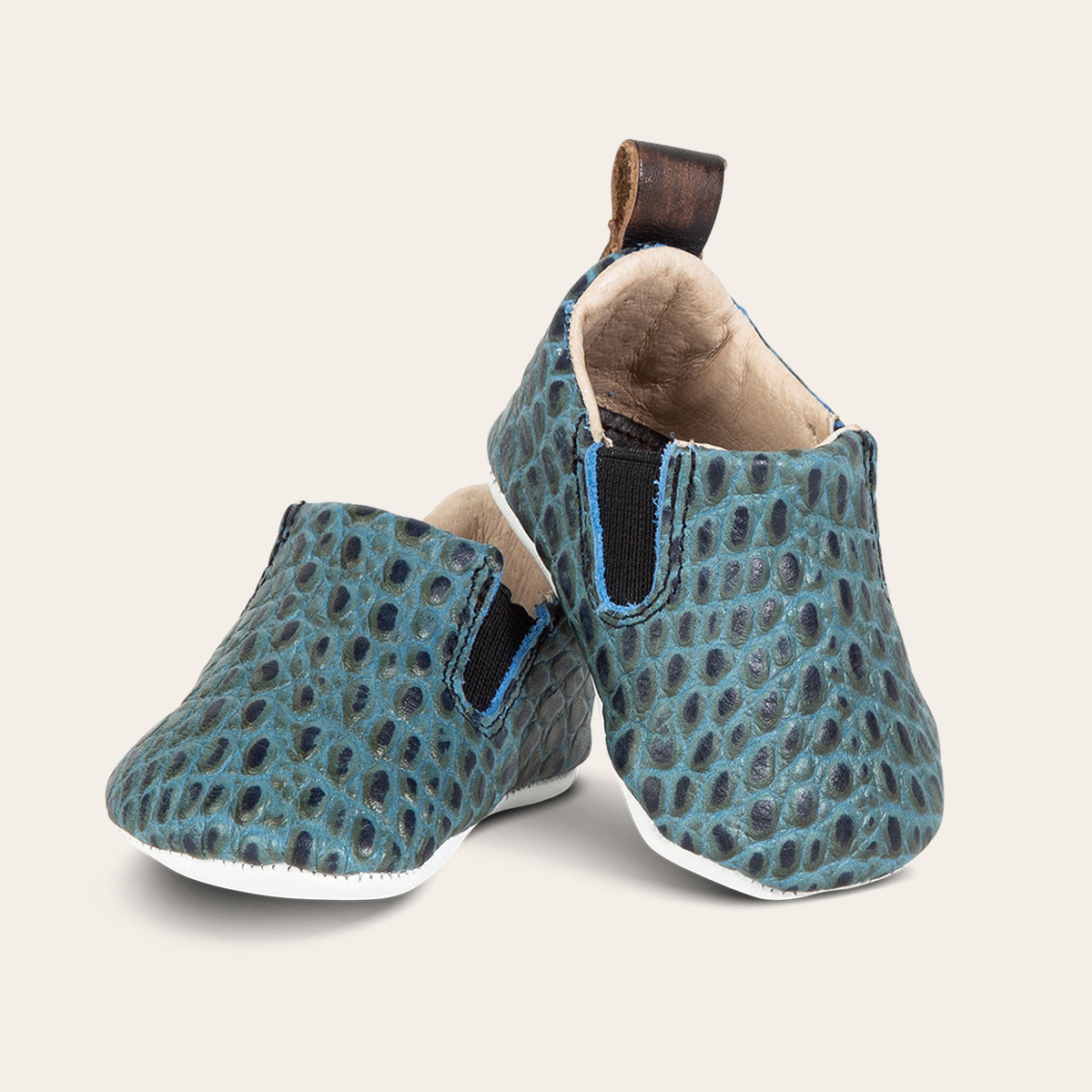 front view showing heel pull tab and side elastic panel on FREEBIRD infant baby kicks turquoise croco leather shoe