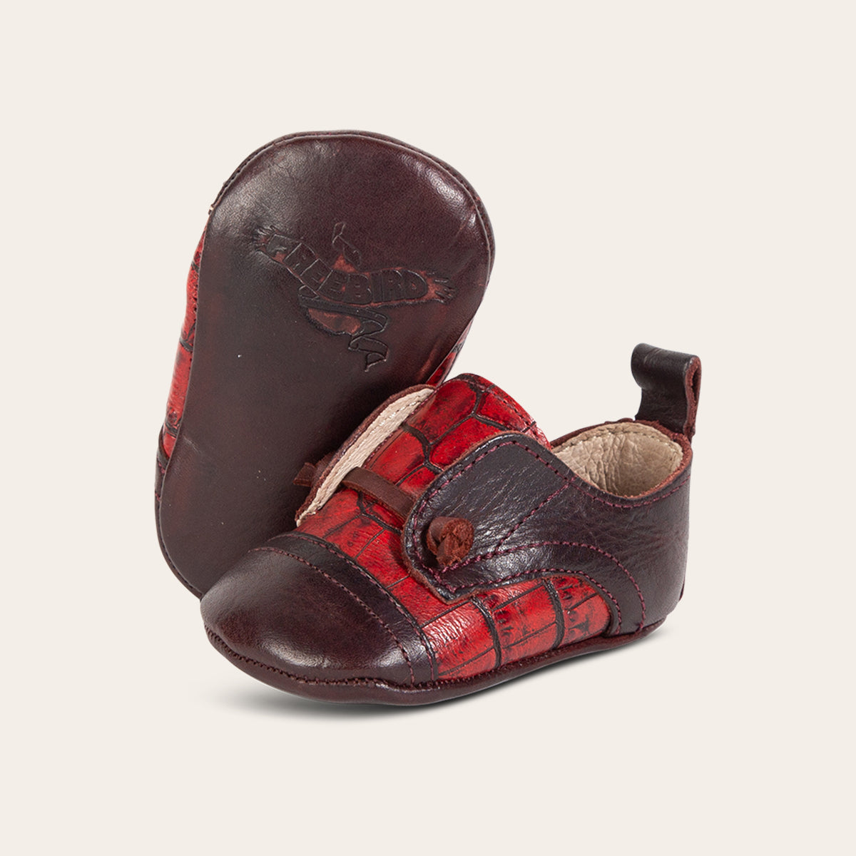 Side view showing decorative knotted leather lace and soft leather imprinted sole on FREEBIRD infant baby Mabel wine multi leather shoe