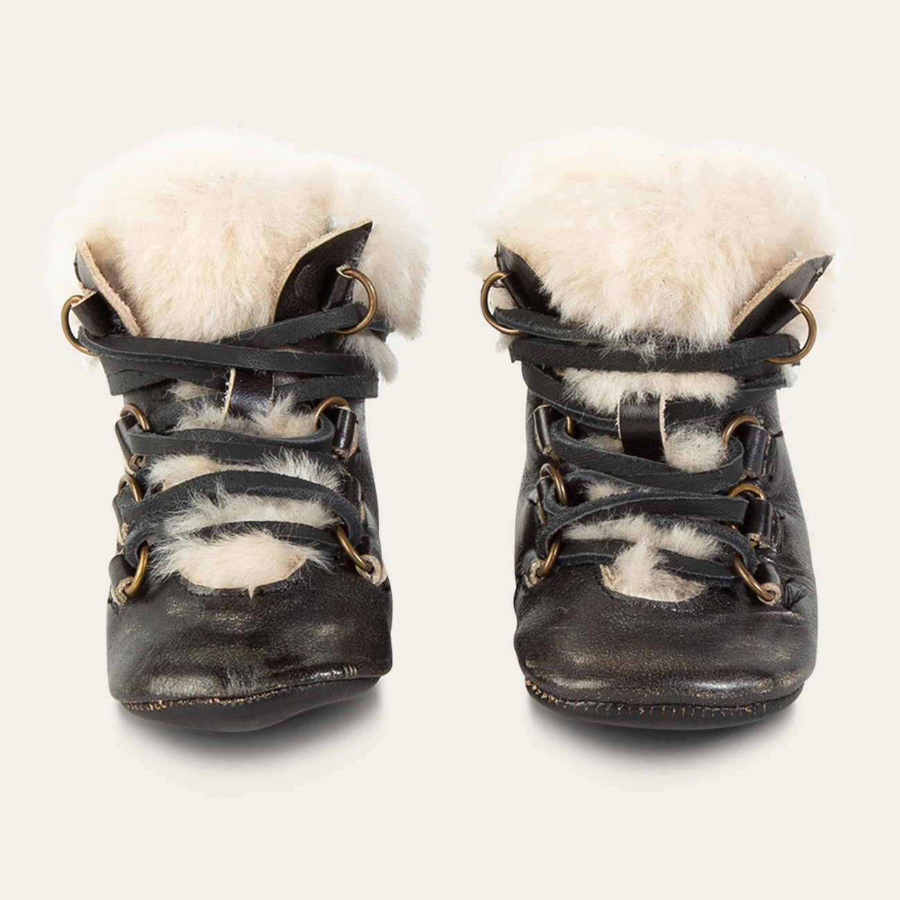 front view showing shearling lining and contrasting leather lace detailing on FREEBIRD infant baby Norway dark olive leather bootie