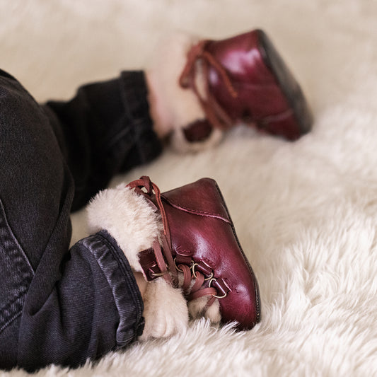 FREEBIRD infant baby Norway wine shearling lined leather bootie with front lacing lifestyle image