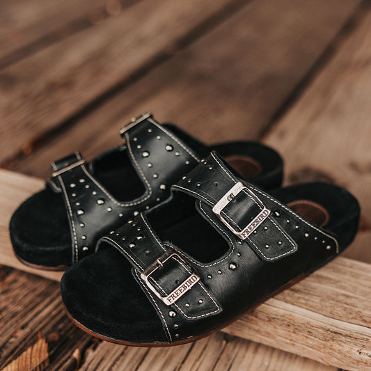 FREEBIRD women's Asher black sandal with adjustable belt buckles, a suede footbed and silver embellishments