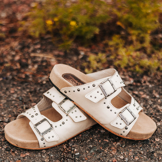 FREEBIRD women's Asher bone sandal with adjustable belt buckles, a suede footbed and silver embellishments