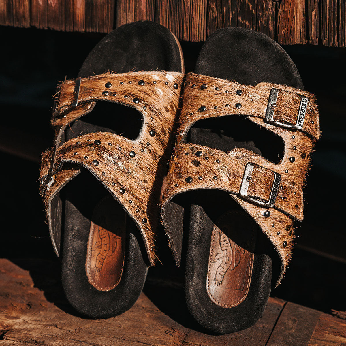 FREEBIRD women's Asher tan multi pony sandal with adjustable belt buckles, a suede footbed and silver embellishments