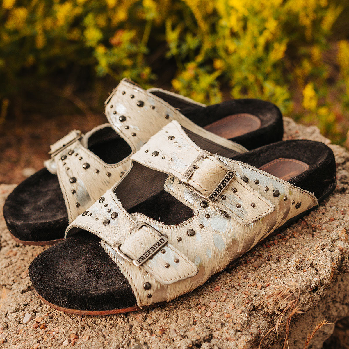 FREEBIRD women's Asher white multi pony sandal with adjustable belt buckles, a suede footbed and silver embellishments