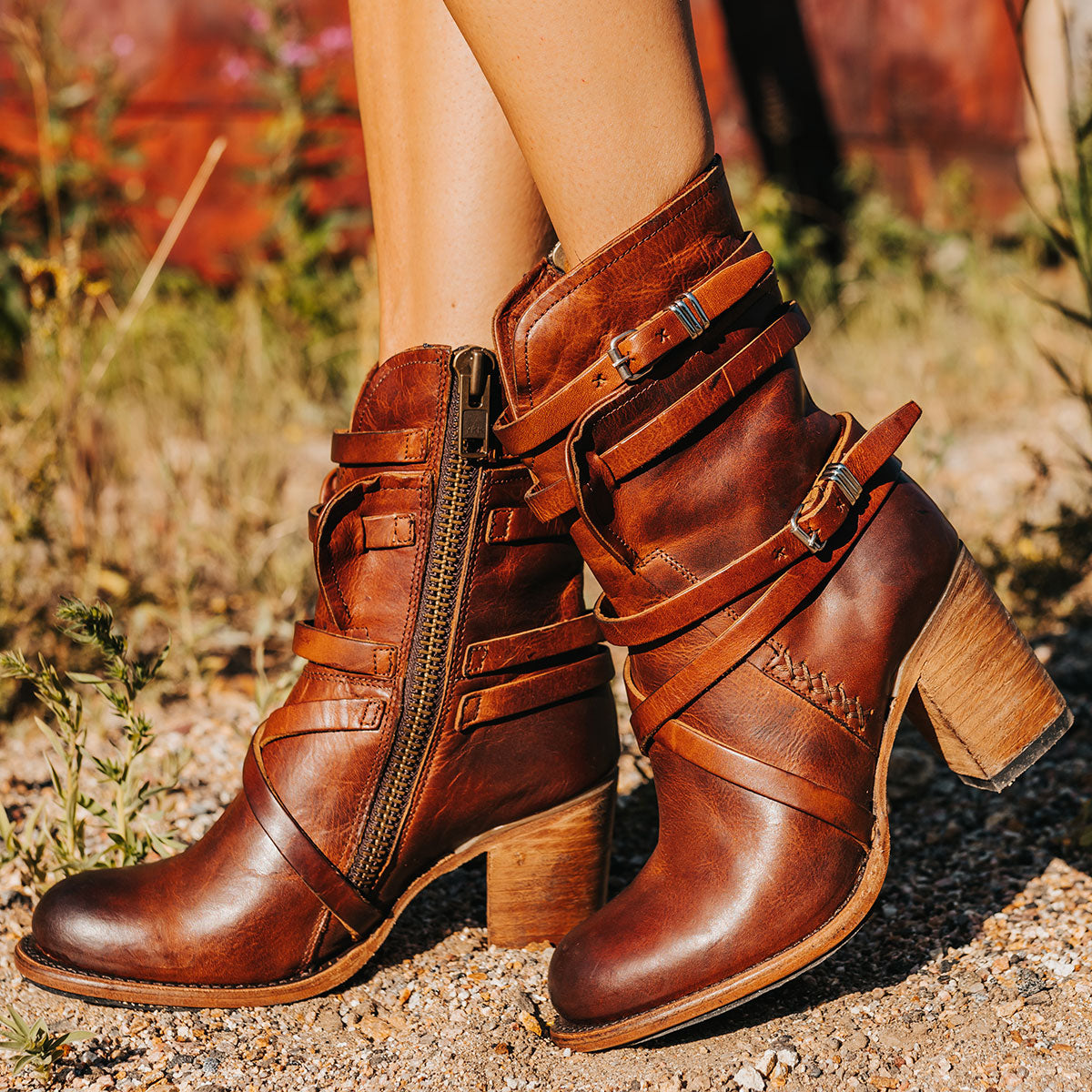 FREEBIRD women's Baker cognac inside brass zip closure boot with fashion straps and stacked heel