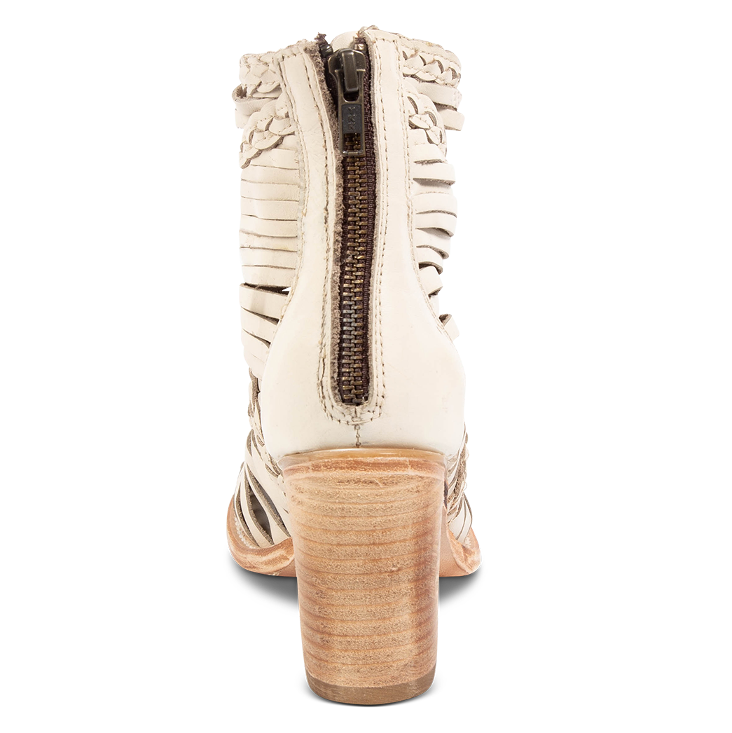 Back view showing a stacked heel and working brass zipper on FREEBIRD women's Bela beige leather sanadal