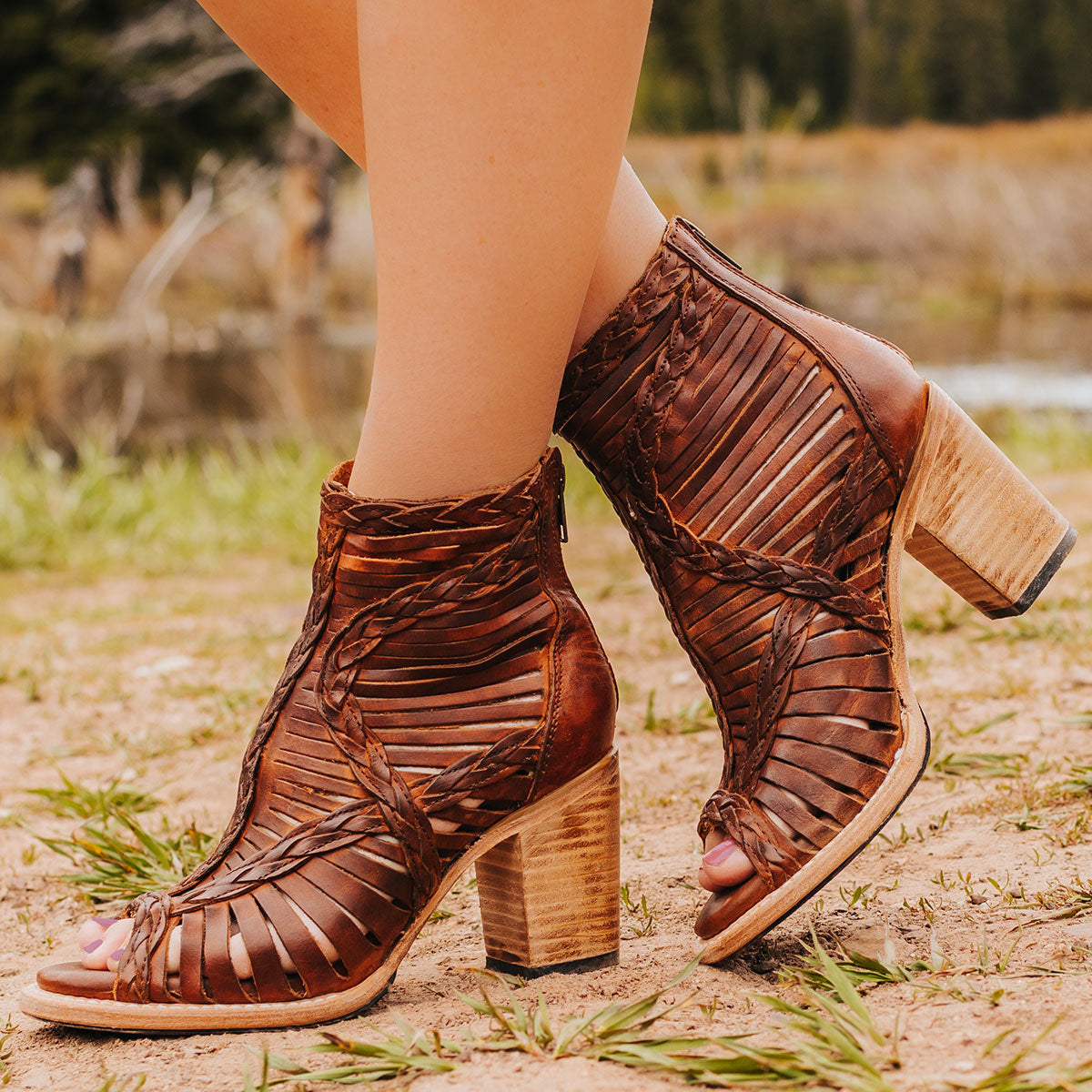 FREEBIRD women's Bela cognac leather sandal with laser cut leather, braided accents and a working brass zip closure