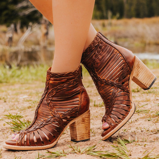 FREEBIRD women's Bela cognac leather sandal with laser cut leather, braided accents and a working brass zip closure