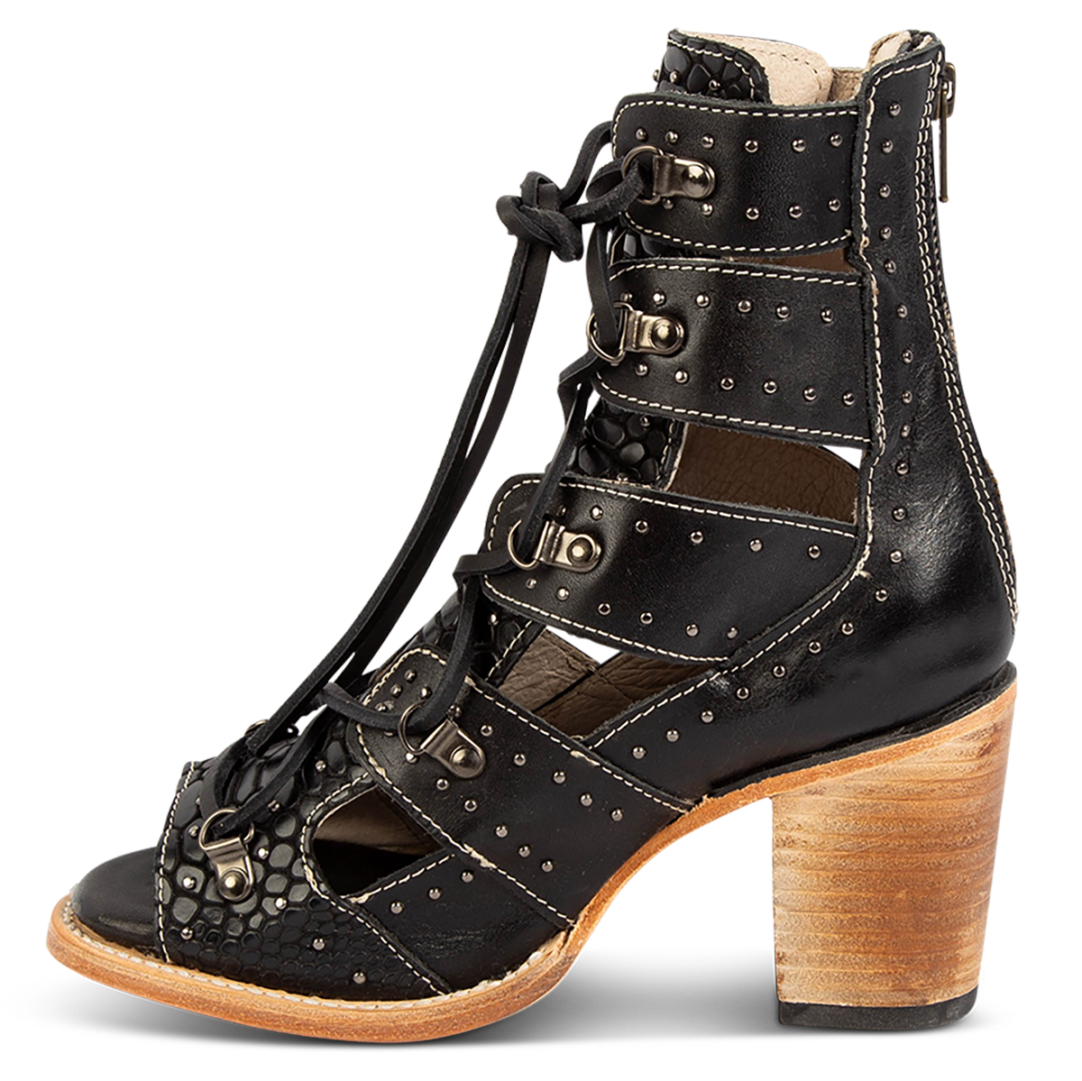 Inside view showing a stacked heel, criss cross leather lacing and stud embellishments on FREEBIRD women's Brandy black snake embossed leather sandal