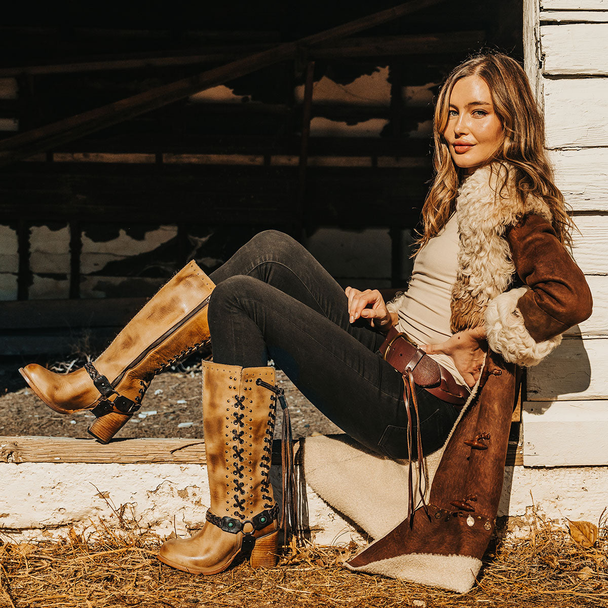 FREEBIRD women's Buck tan leather tall boot with shaft lacing and stud detailing lifestyle image