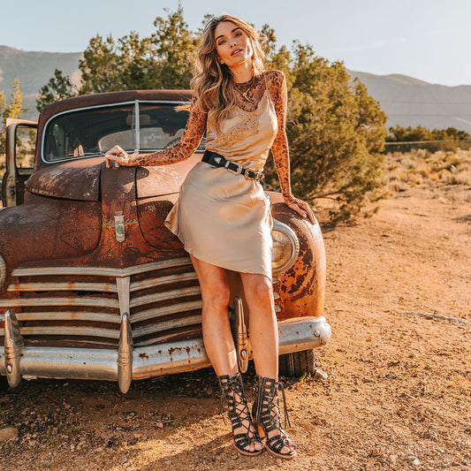 FREEBIRD women's BUD black leather sandal with laser-cut heel paneling, front leather lacing, silver stud detailing and a lifted heel lifestyle