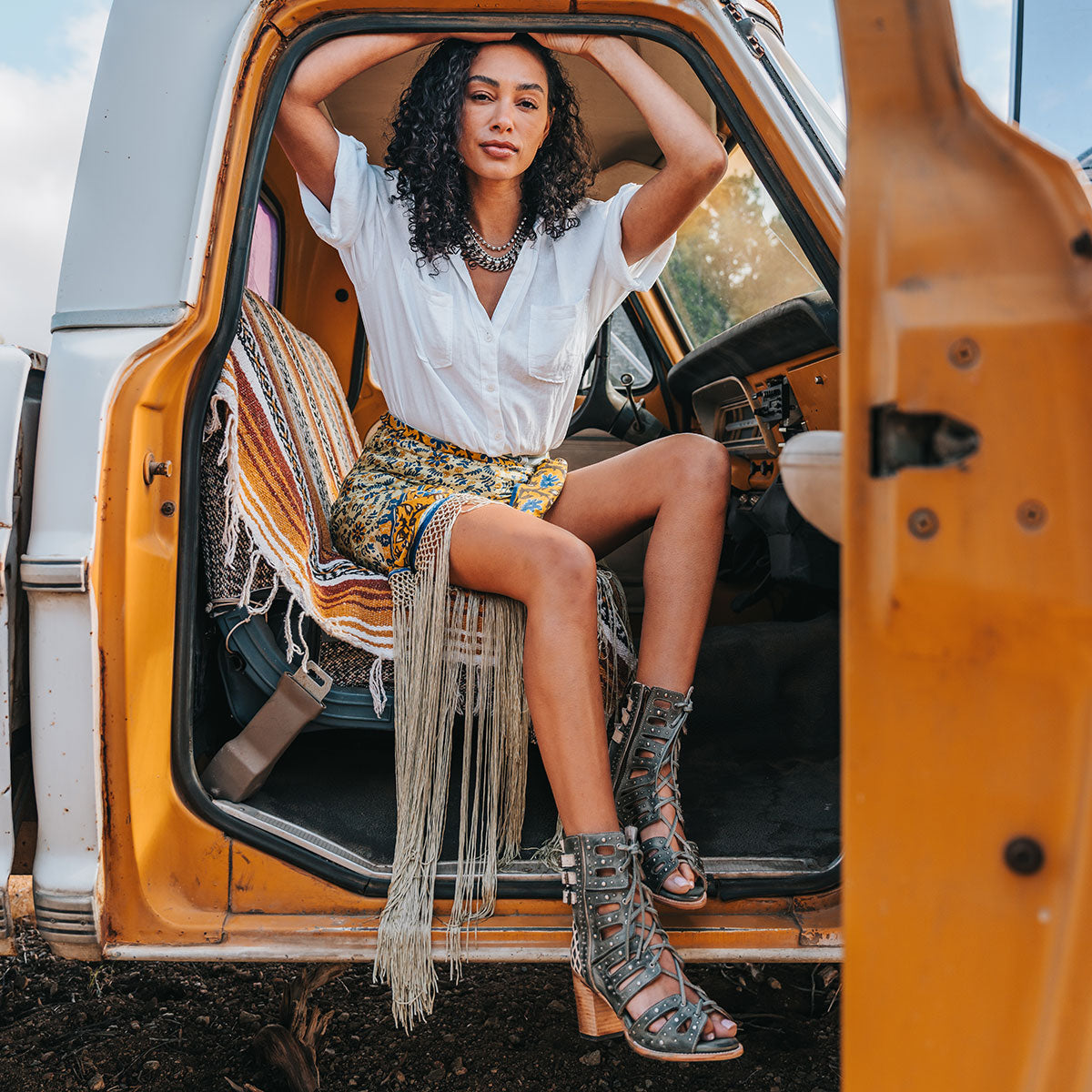 FREEBIRD women's BUD blue leather sandal with laser-cut heel paneling, front leather lacing, silver stud detailing and a lifted heel lifestyle