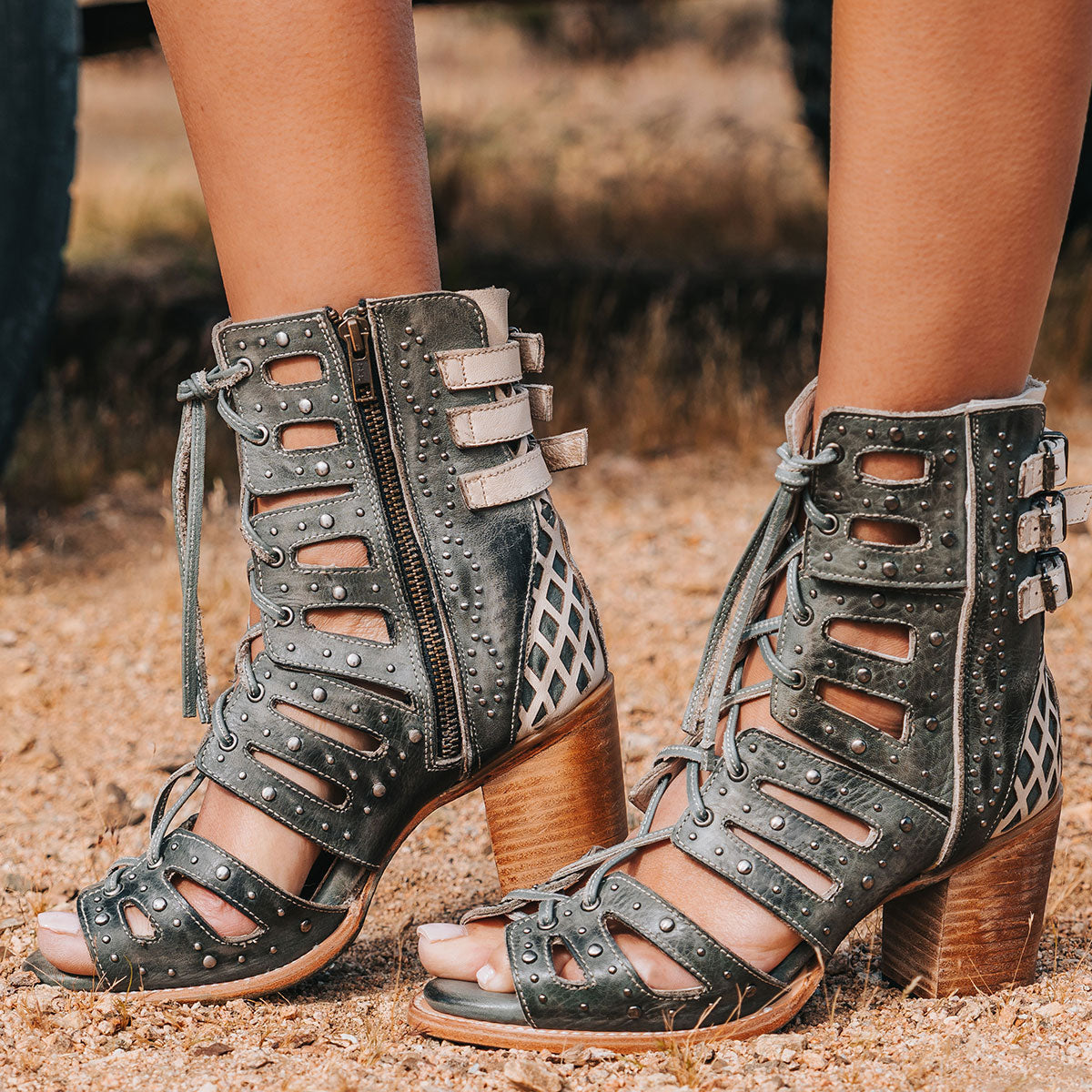 FREEBIRD women's BUD blue leather sandal with laser-cut heel paneling, front leather lacing, silver stud detailing and a lifted heel 