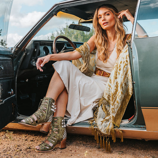 FREEBIRD women's BUD green leather sandal with laser-cut heel paneling, front leather lacing, silver stud detailing and a lifted heel lifestyle