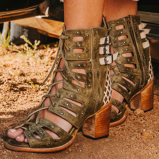 FREEBIRD women's BUD green leather sandal with laser-cut heel paneling, front leather lacing, silver stud detailing and a lifted heel