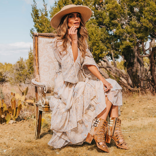 FREEBIRD women's BUD tan leather sandal with laser-cut heel paneling, front leather lacing, silver stud detailing and a lifted heel lifestyle