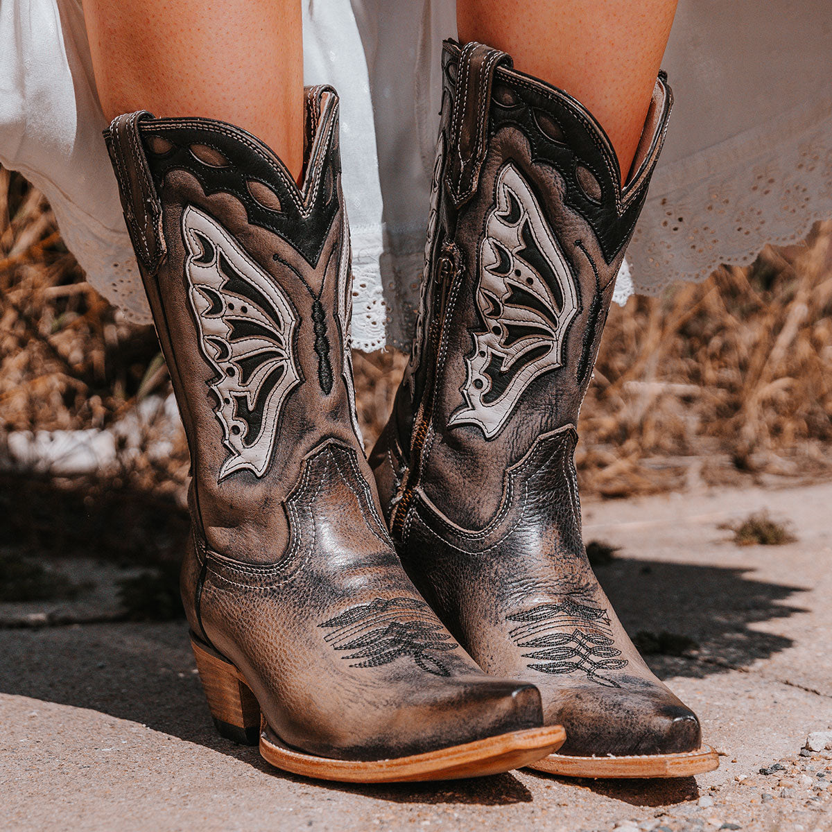 FREEBIRD women's Butterfly black multi leather boot with laser cut detailing, a slant heel and snip toe construction